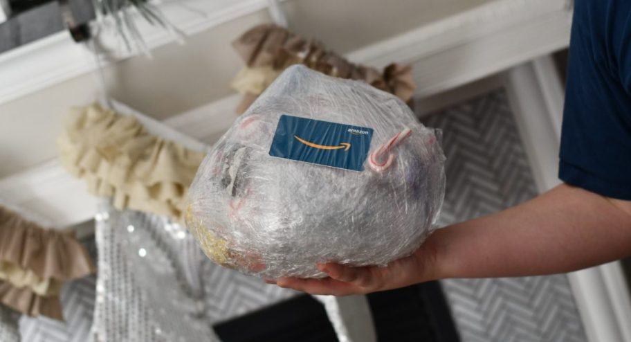 a ball of saran wrap filled with christmas presents