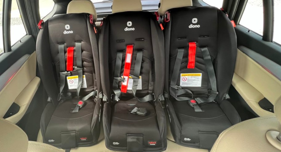 three black car seats side by side