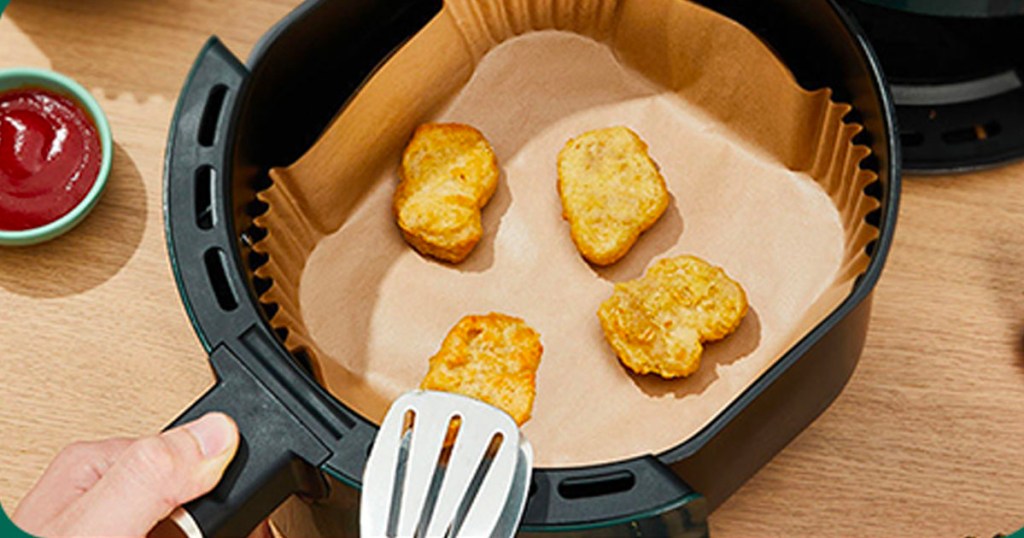 chicken nuggets on parchment paper in air fryer