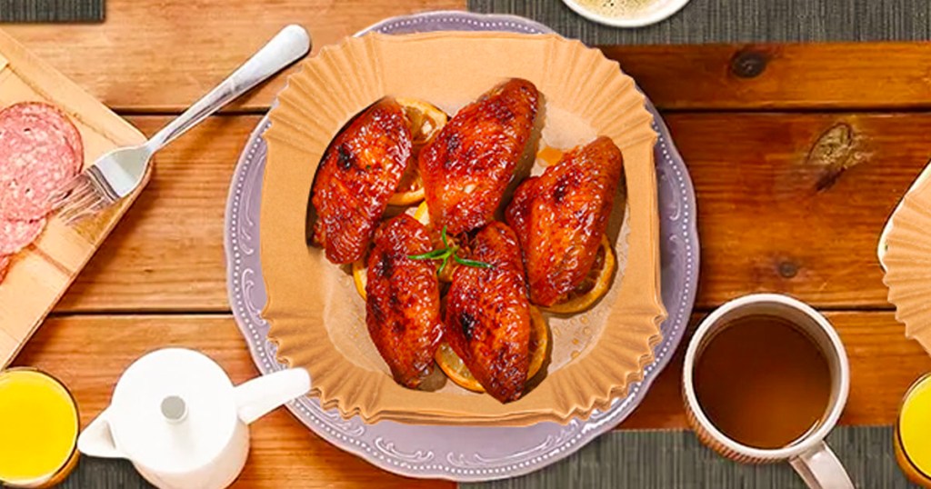 chicken wings in air fryer parchment paper on plate