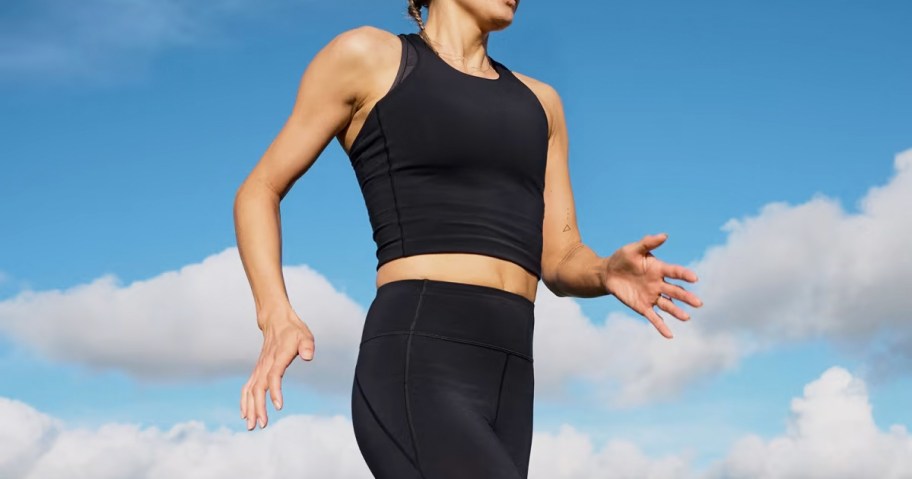 woman running in black tank and leggings