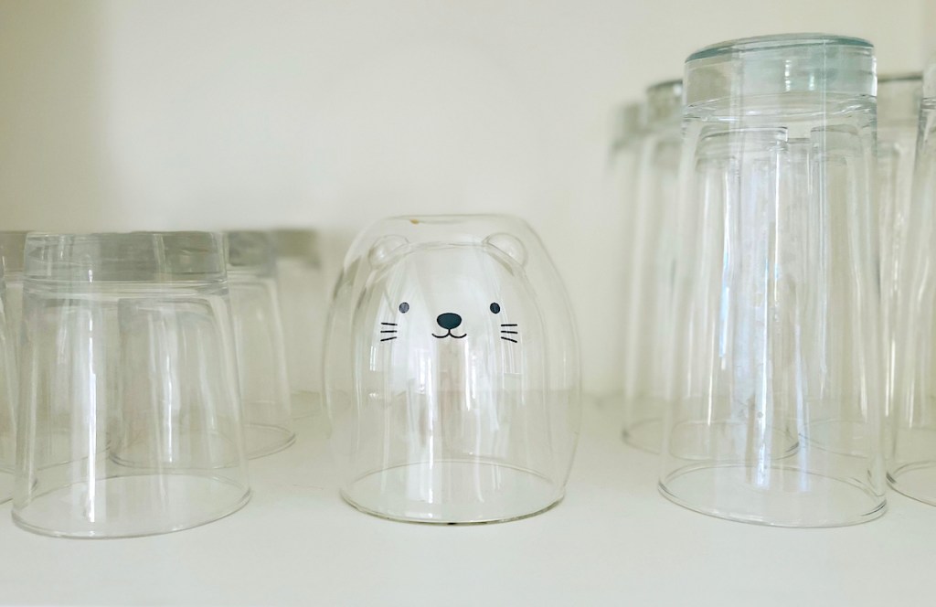 double wall glass cat mug sitting in cup cabinet