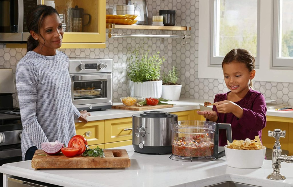 mom and daughter making things in a ge small appliance food processor