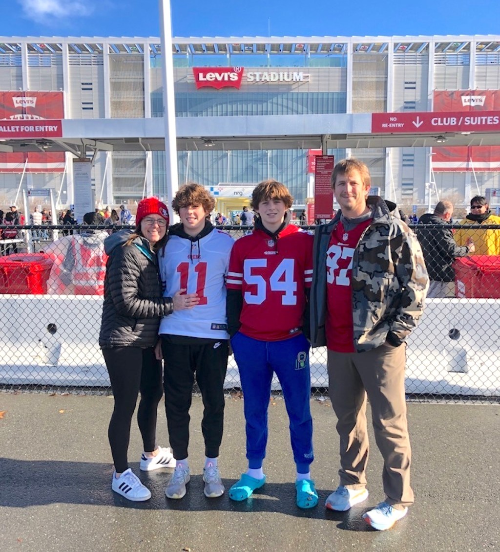 family standing outside of nfl football stadium