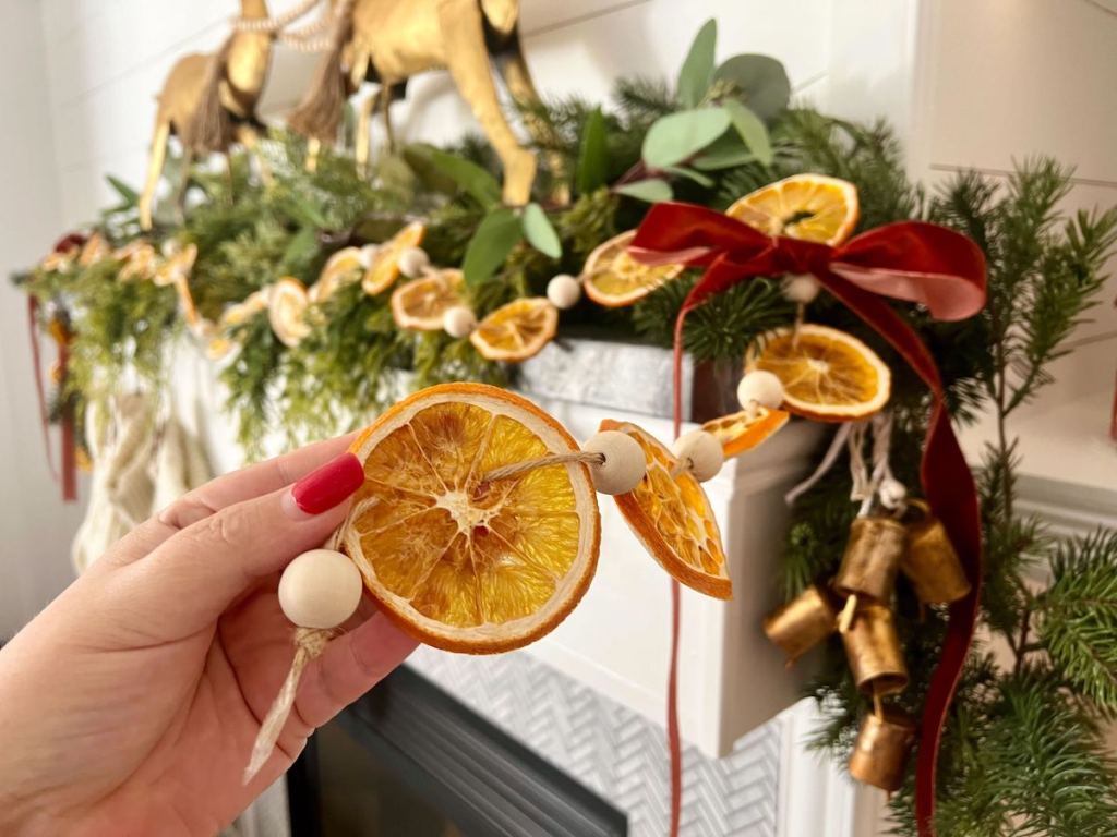 hand holding orange wood bead garland