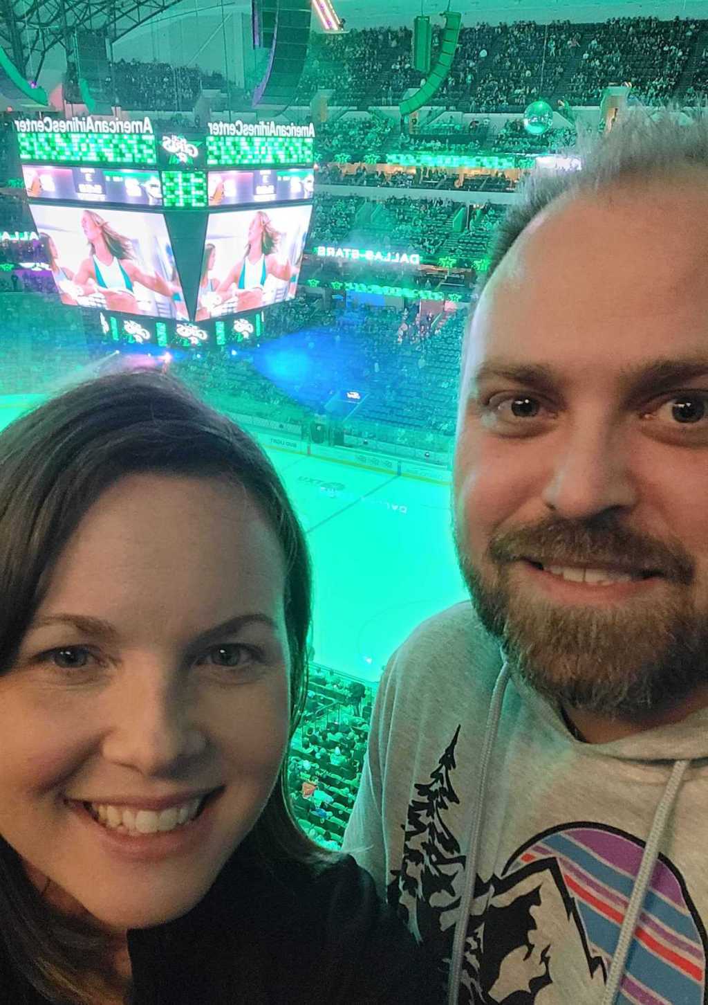 couple taking selfie at hockey game