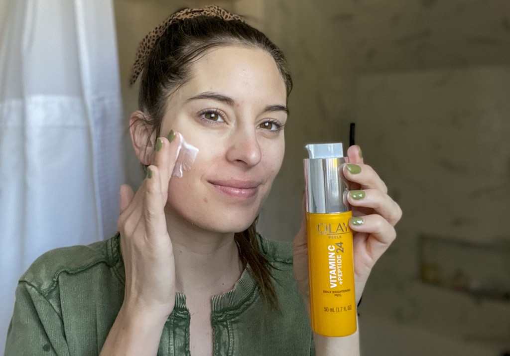 woman using olay vitamin c peel serum