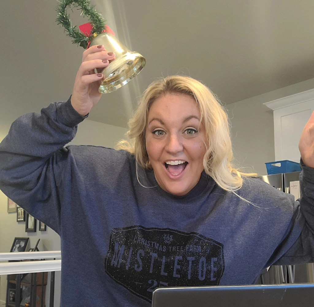 woman wearing christmas sweater with jingle bell