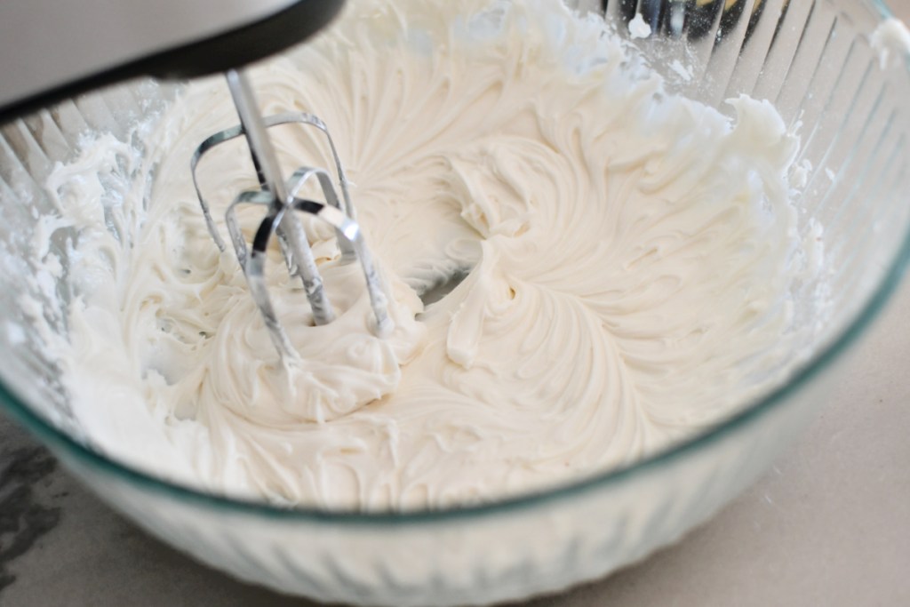 mixing frosting for gingerbread cookies