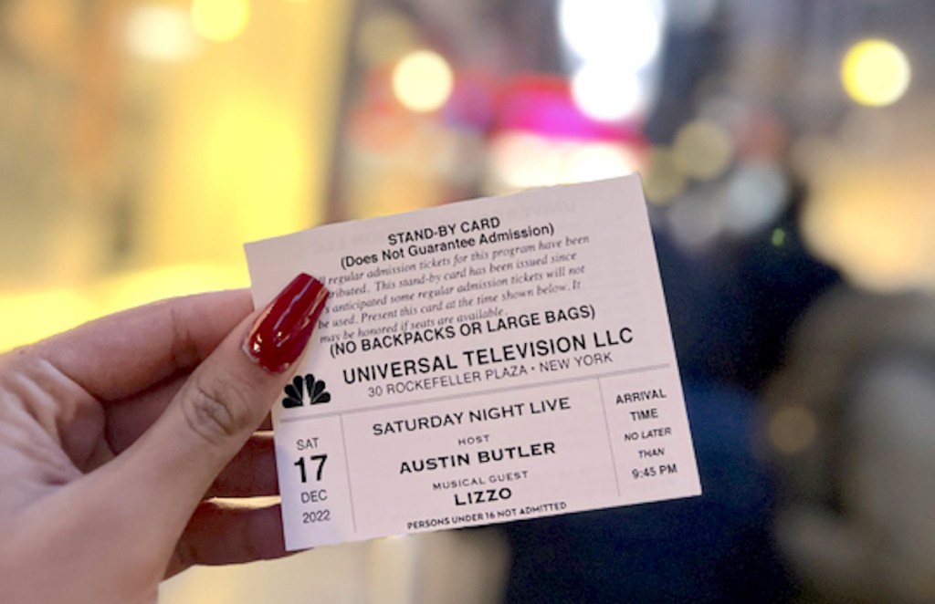 hand holding an snl ticket outside in nyc