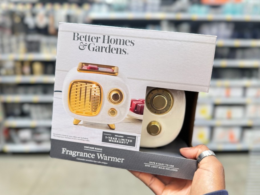 hand holding a retro radio shaped wax warmer in a box at Walmart