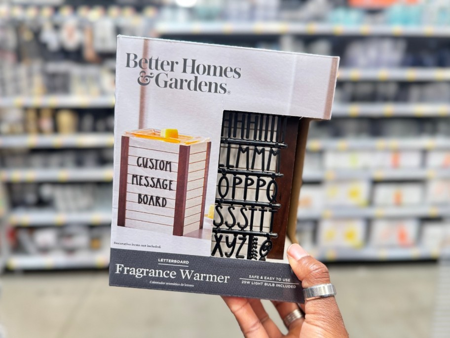 hand holding a letterboard wax warmer in a box at Walmart