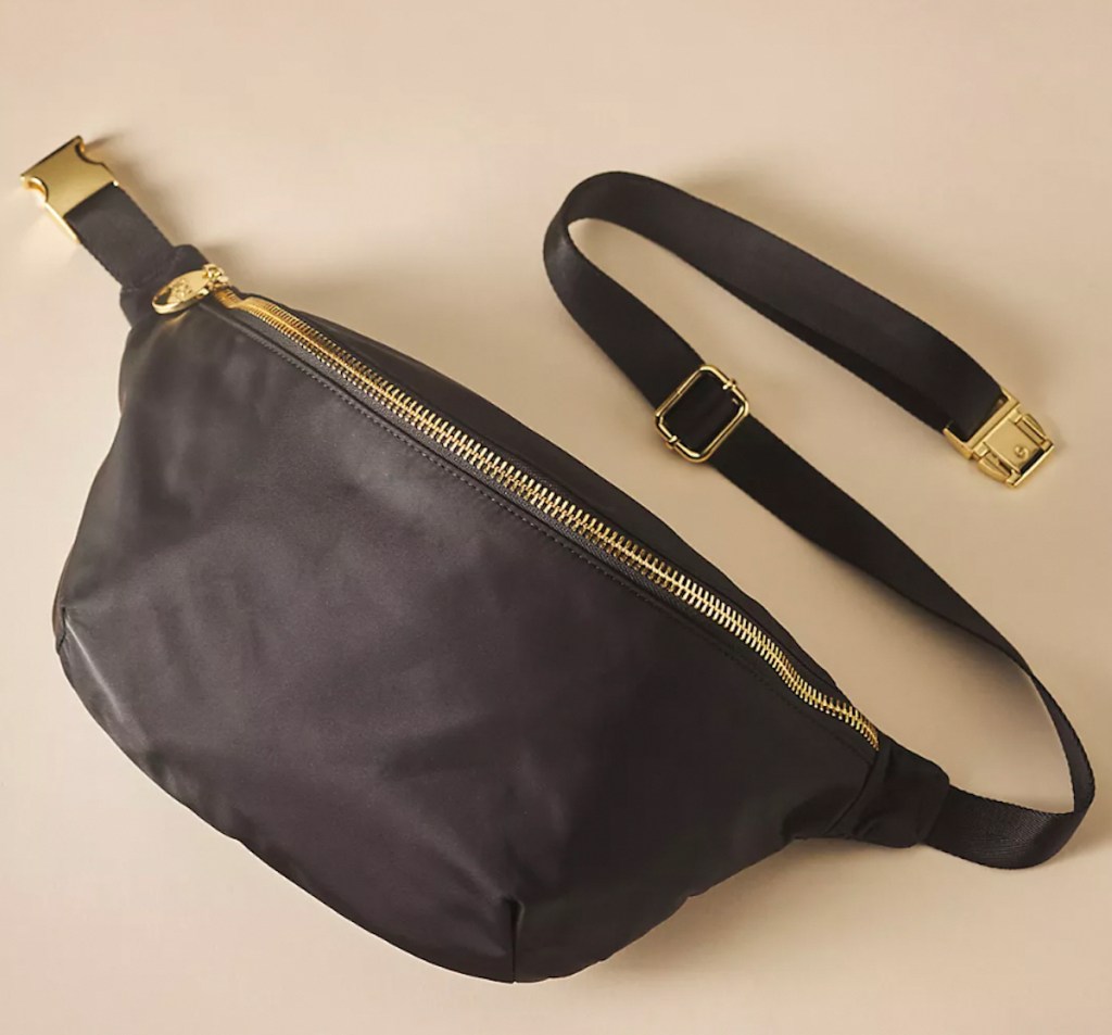 black belt bag on beige background anthropologie clothes