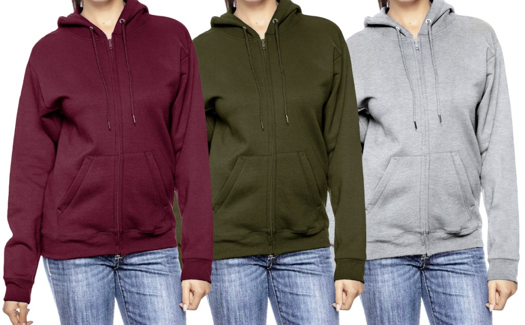 three women in maroon, green, and light grey hoodies