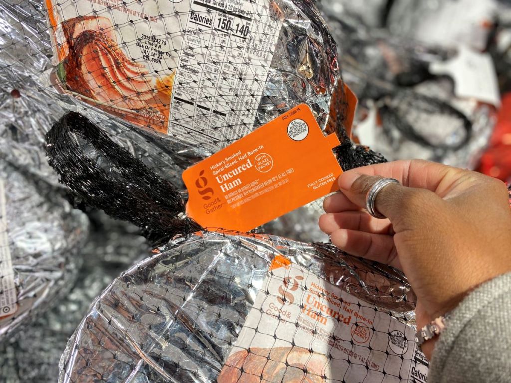 Hand holding the tag on a Good & Gather ham at Target