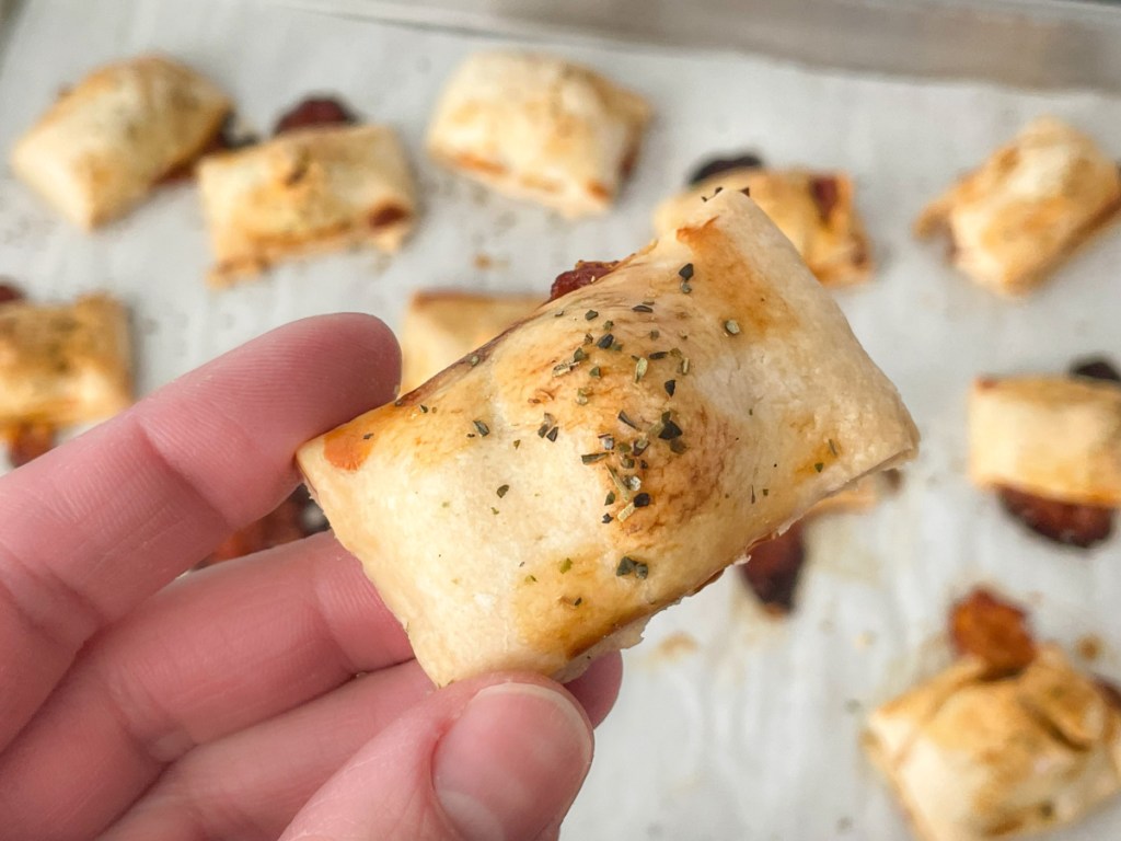 holding a homemade pizza bite