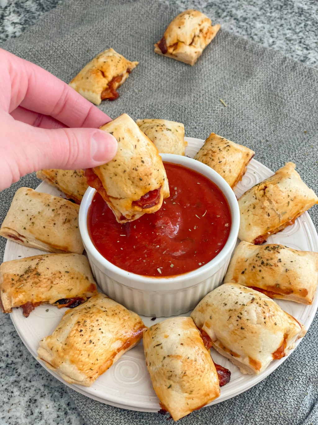 dipping a pizza bite in marinara sauce