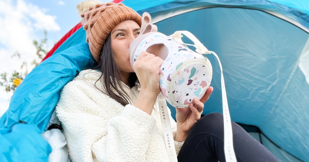 woman drinking from hydrojug