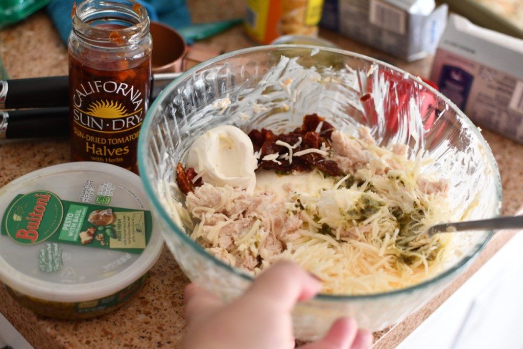 a mixing bowl full of dip mix being used to make a 4 dip appetizer on 1 pan