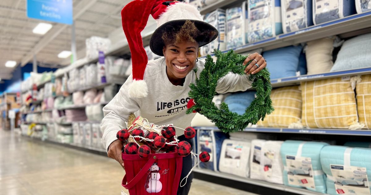 woman holding christmas decor in At Home