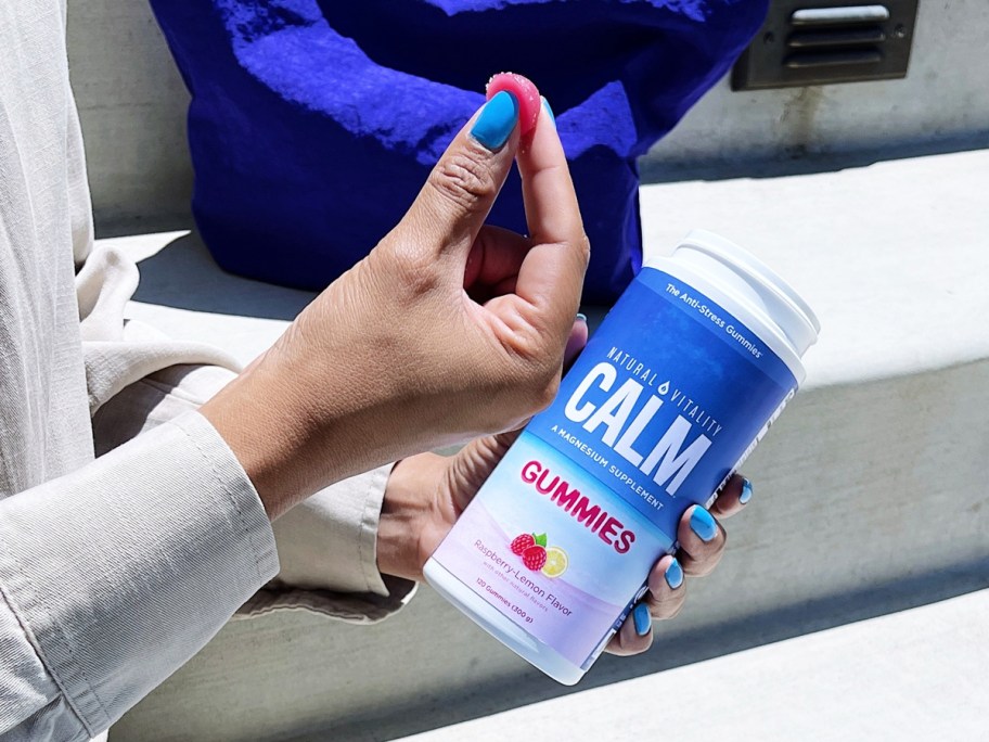 woman holding a bottle of Natural Vitality Calm Gummies