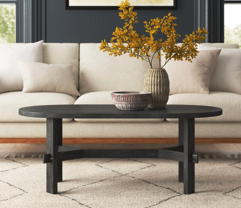 black coffee table in staged living room with decor 