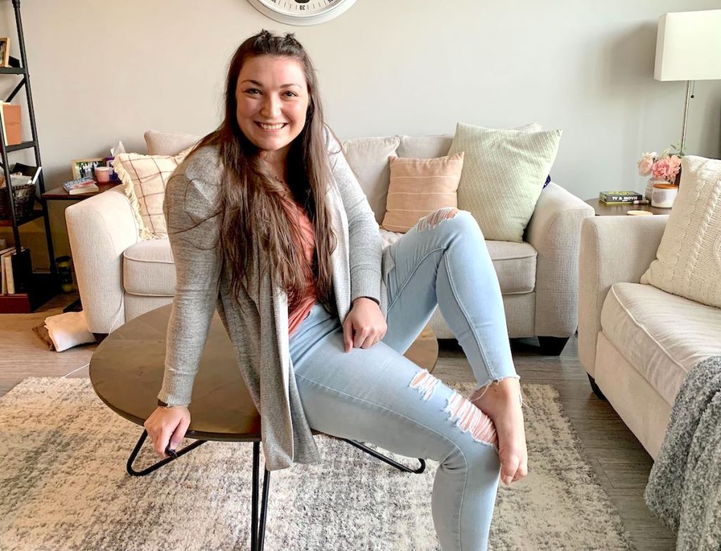 woman sitting on chair in middle of living room 