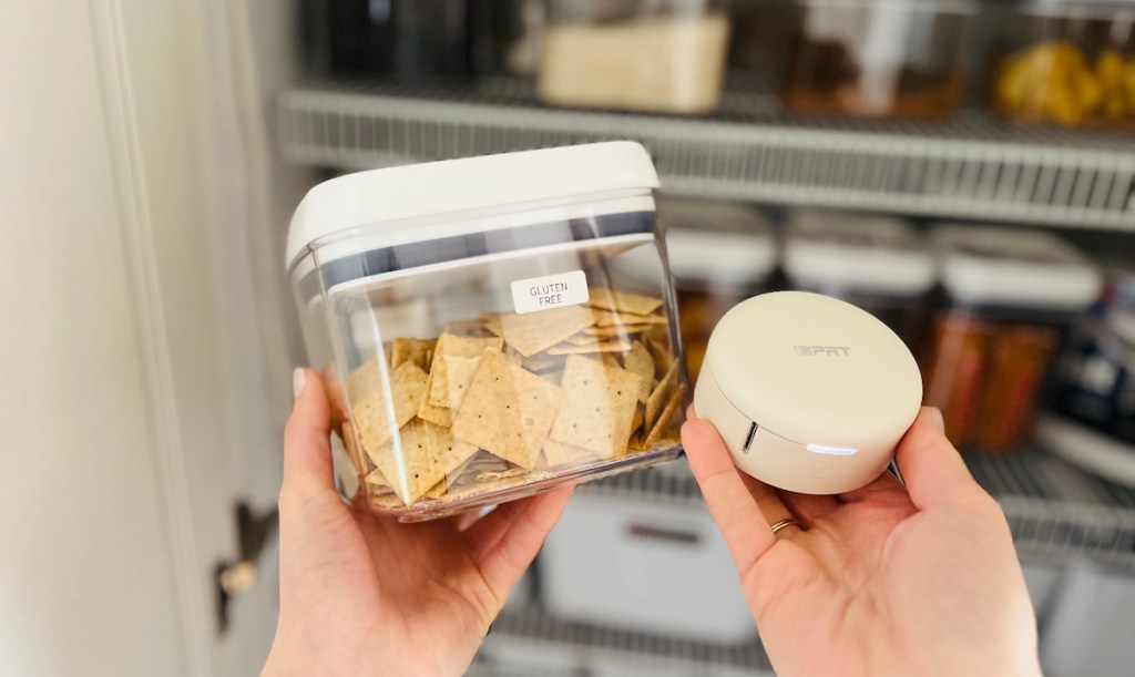 hand holding label maker and container of gluten free crackers 