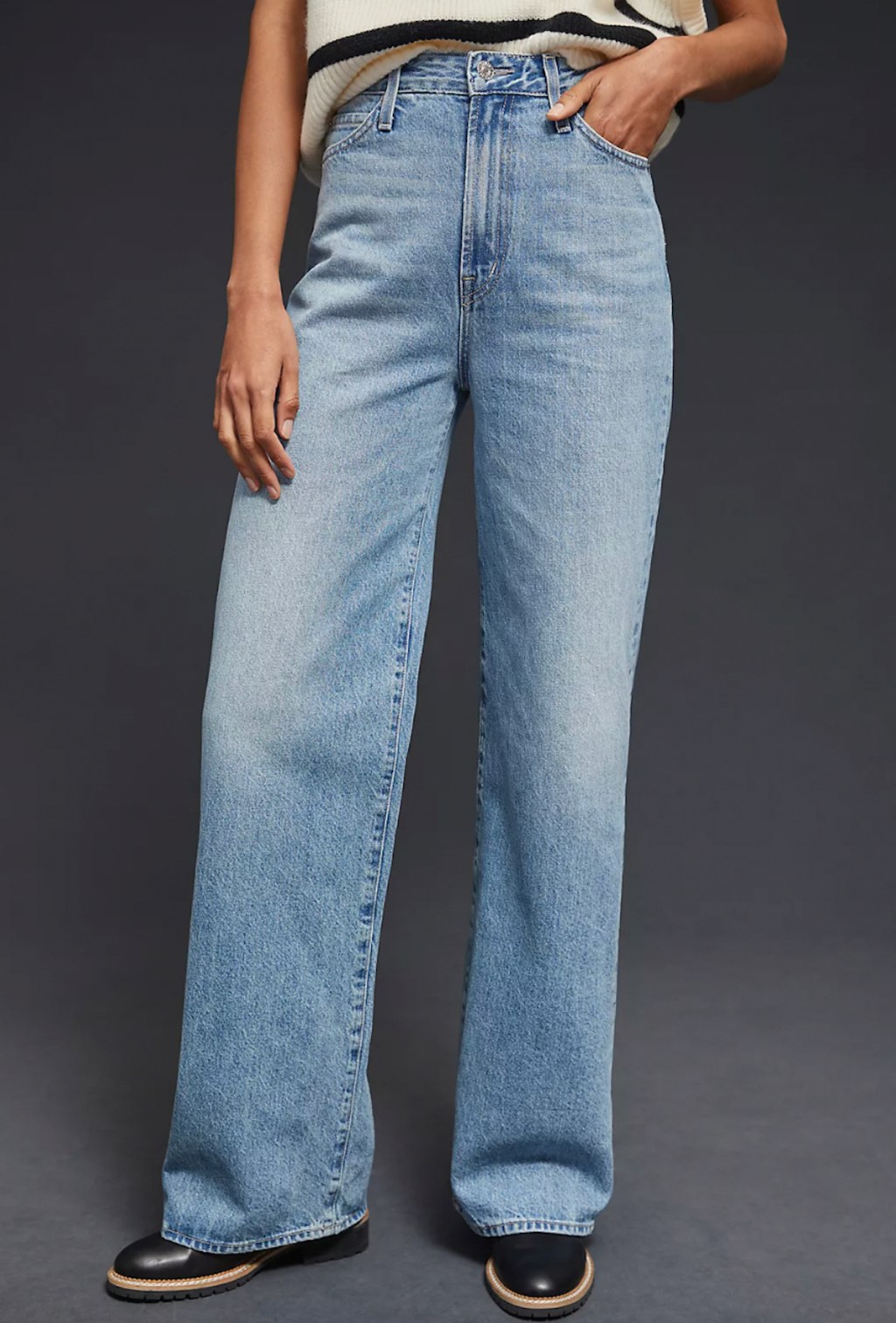 anthropologie clothes stock photo of model posing in medium wash wide leg denim jeans