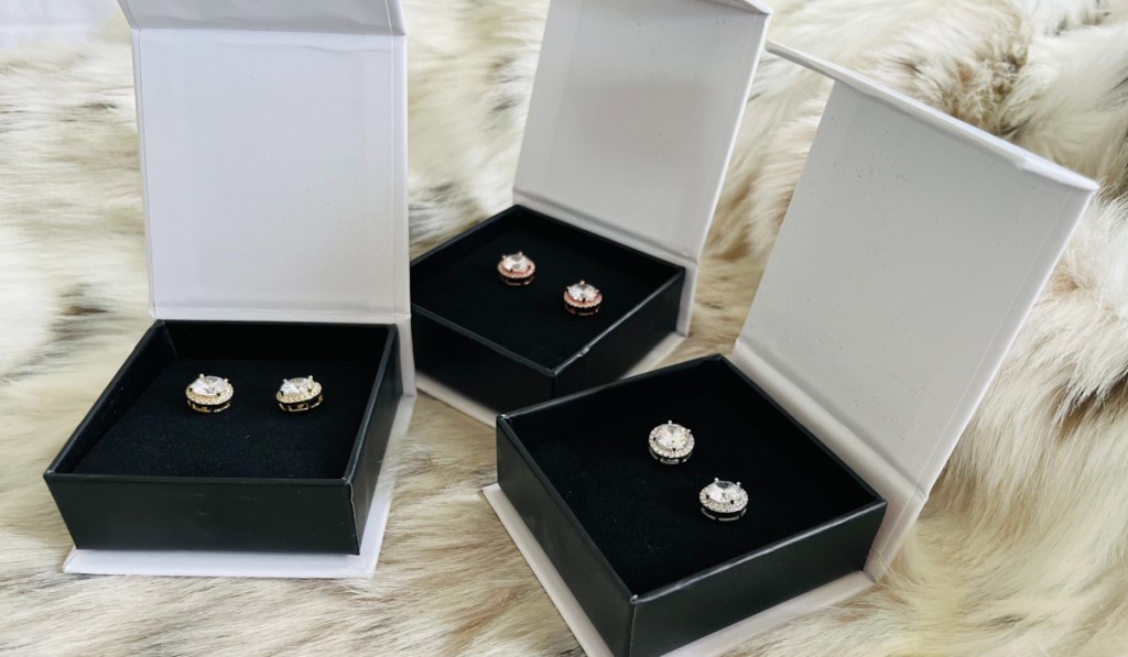 3 pairs of stud earrings in boxes