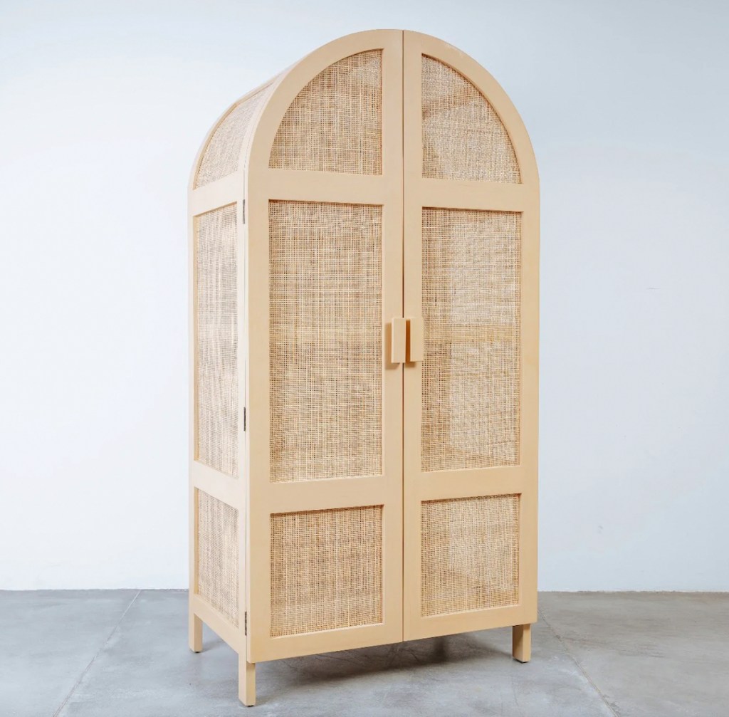 caned storage cabinet in empty space with concrete floor 