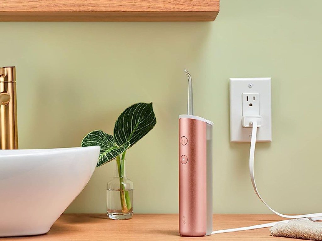 rose gold water flosser in bathroom 