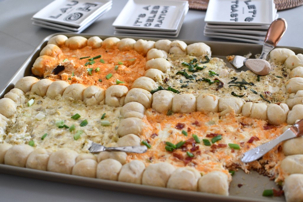 sheet pan with round dough balls and four different cheese dips