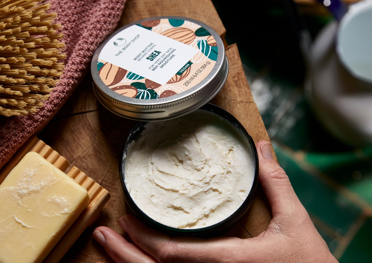 hand grabbing opened body butter