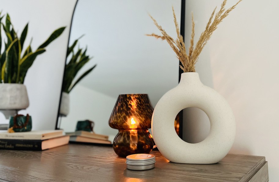 dresser with brown mushroom lamp and white circle vase