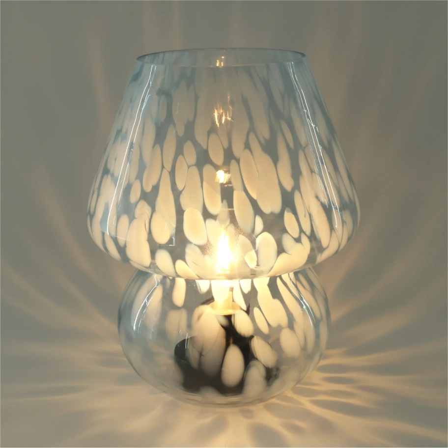 white speckled mushroom lamp with light casting on background