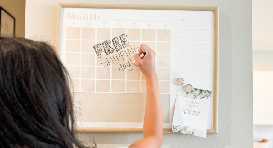 women writing on monthly calendar with items displayed om it