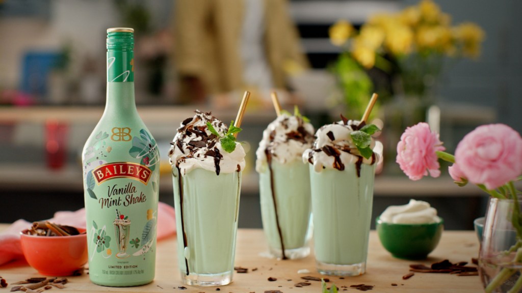 A bottle and 3 milkshake cups of Baileys Vanilla Mint Shake 