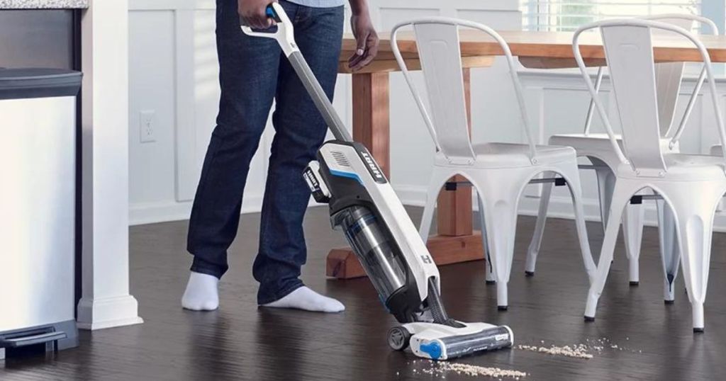 Man using a HART cordless stick vacuum