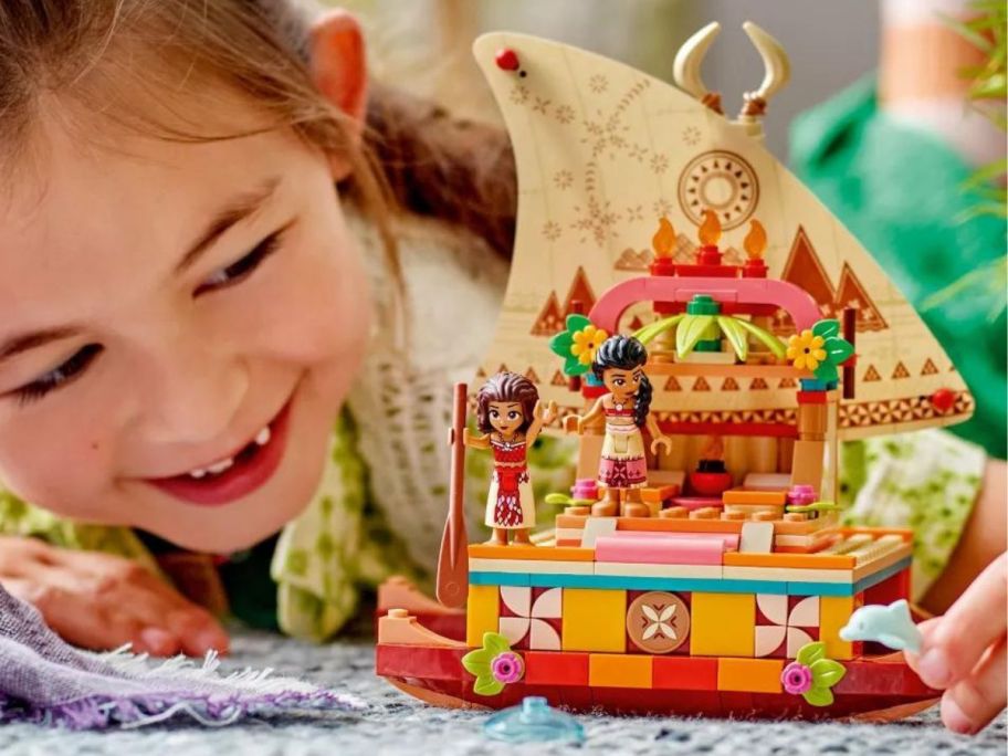 Little girl playing with the Lego Moana Wayfinding Boat