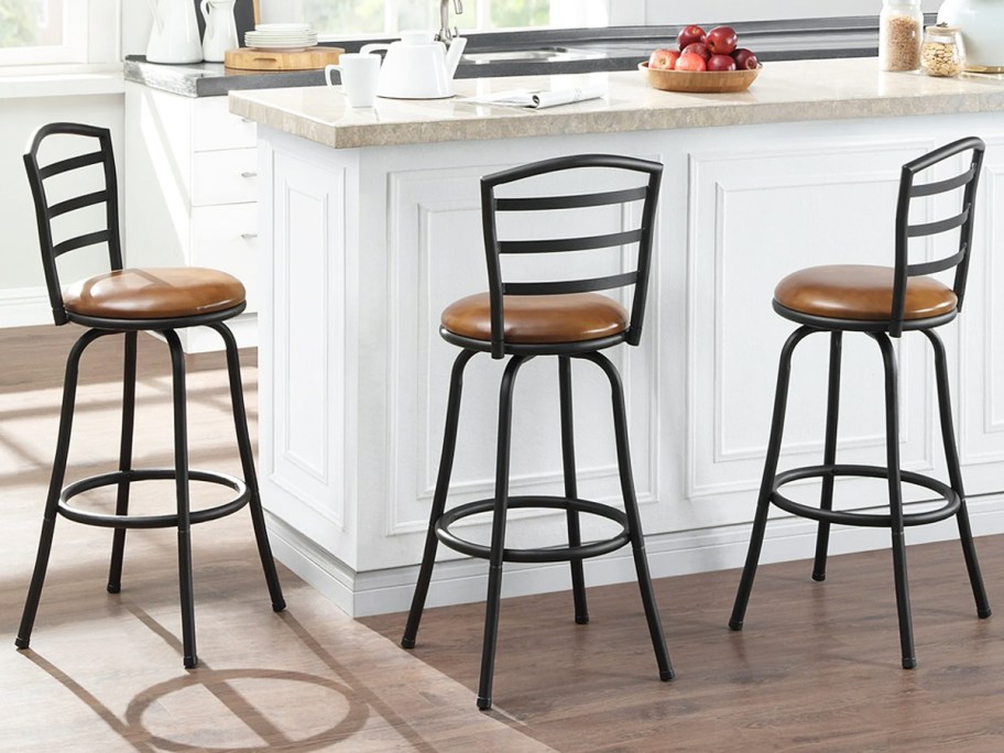 three black and brown barstools at kitchen counter