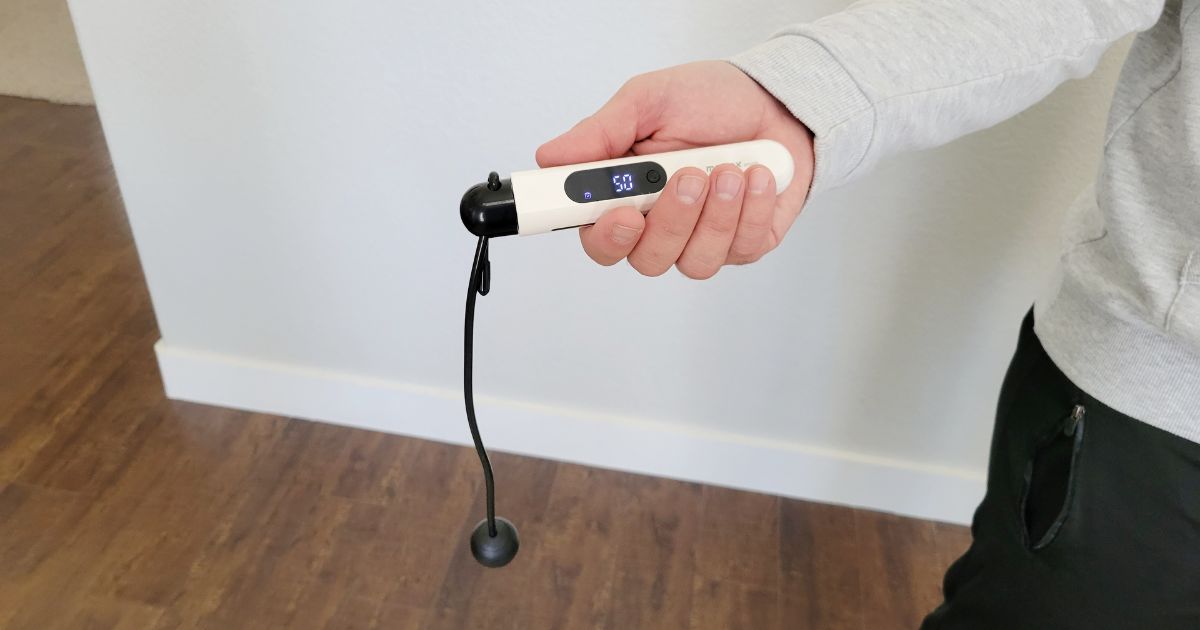 man holding a jump rope in one hand