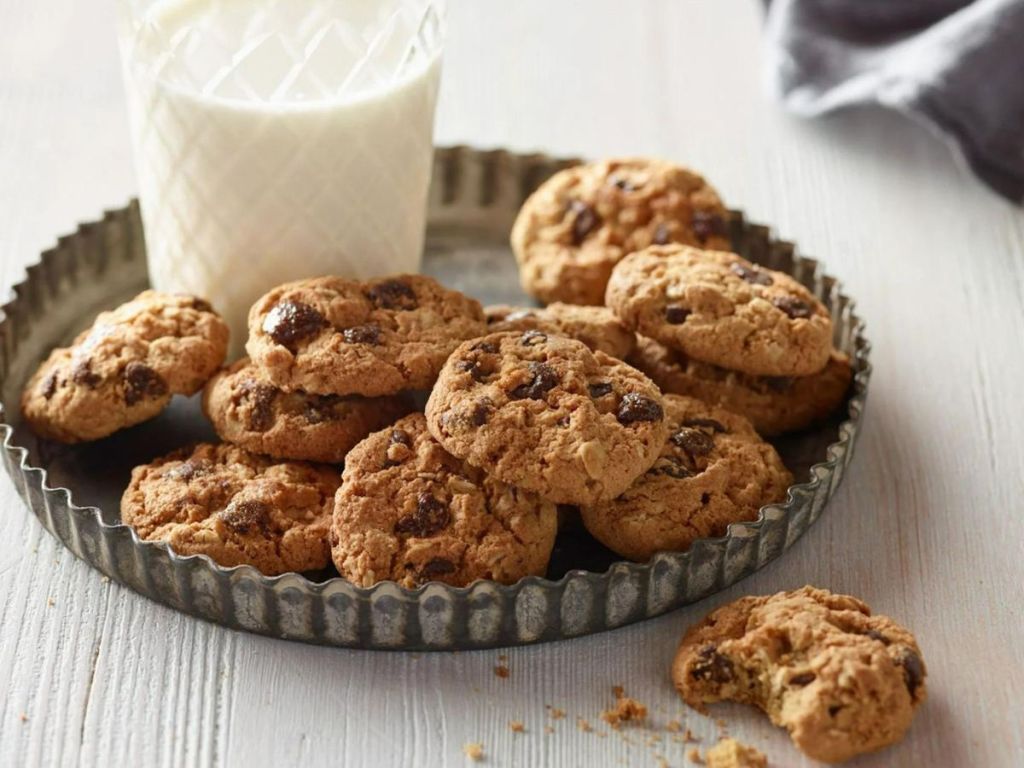 Munchkin Lactation Cookies on a plate with a glass of milk