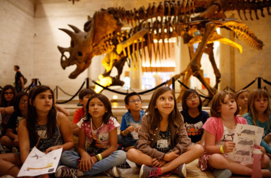 Children in the dinosaur exhibit at the Natural History Museum of Los Angeles County, one of the museums that give ebt card holders free or discounted admission