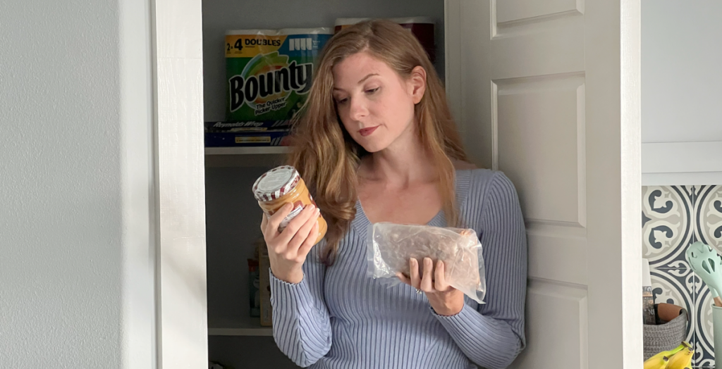 woman looking in pantry to make pantry with food already in her home