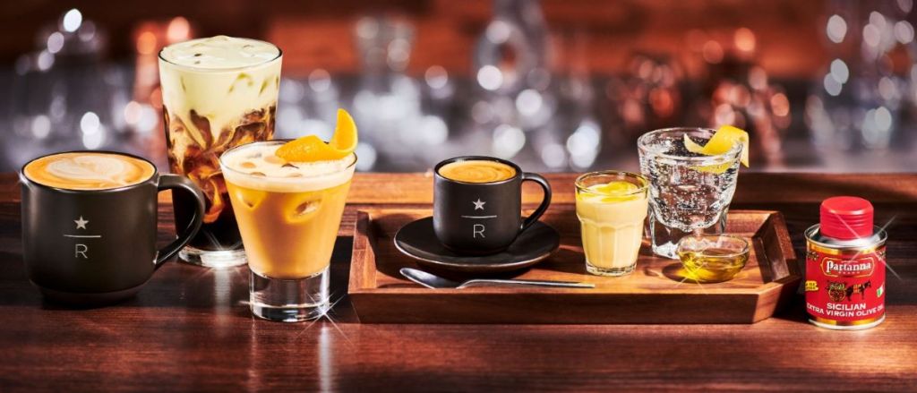 Counter with a variety of Starbucks drinks in glasses and mugs