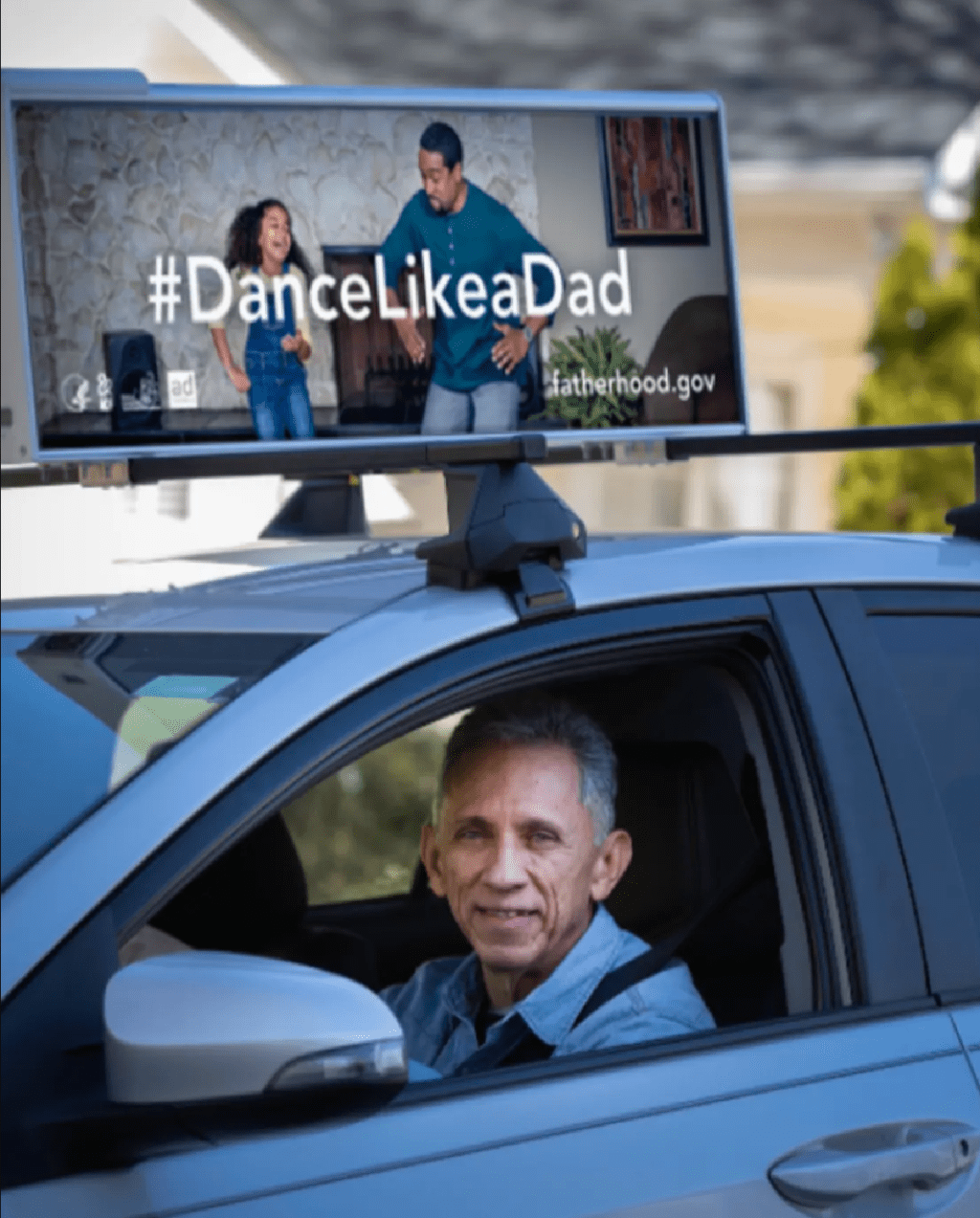 get paid to advertise on your car like this man driving a vehicle with car advertising on top