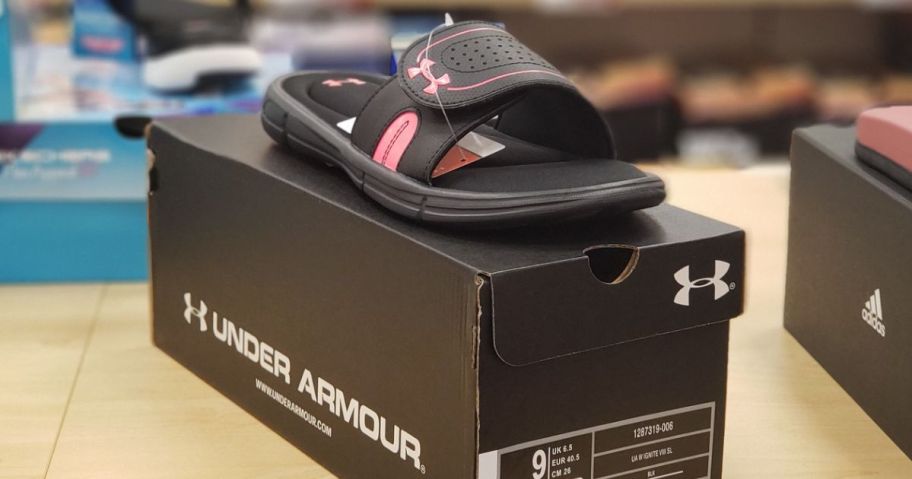 one Under Armour Ignite women's slide on top of the box they onlinee in