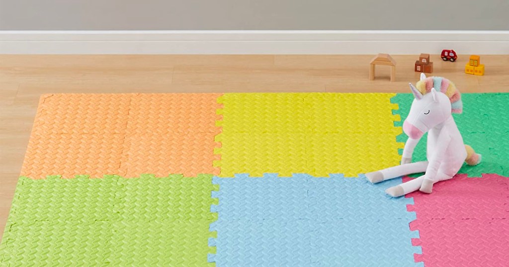 foam exercise playmat on floor with unicorn toy