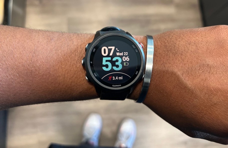 close up of arm wearing black garmin watch